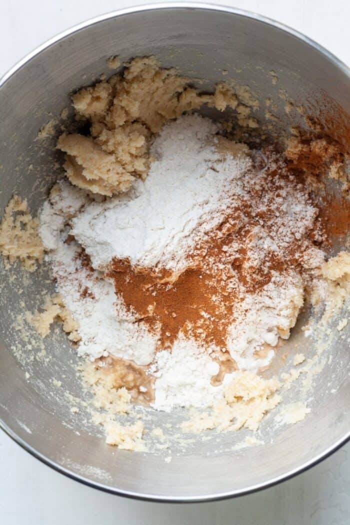 Flour, cinnamon and dough in bowl