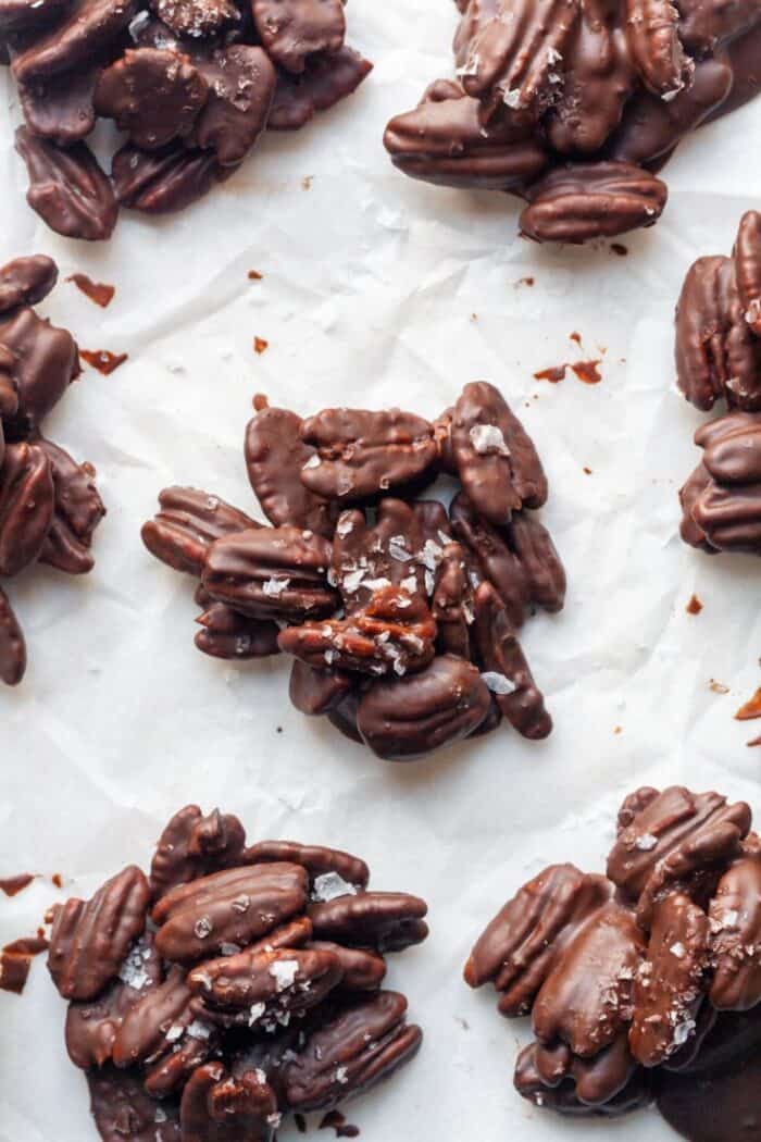 Chocolate covered pecans on parchment paper