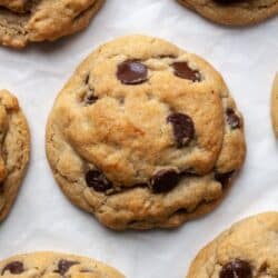 Eggless chocolate chip cookies on parchment paper