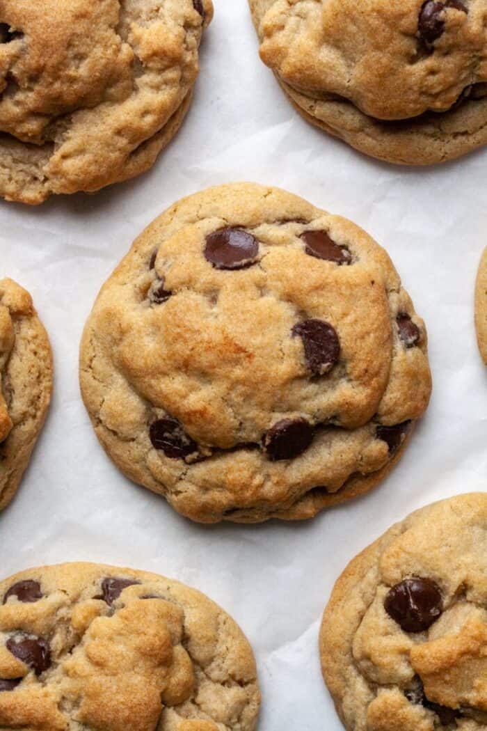 Eggless chocolate chip cookies on parchment paper