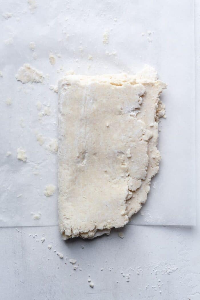 Folded dough on flour surface