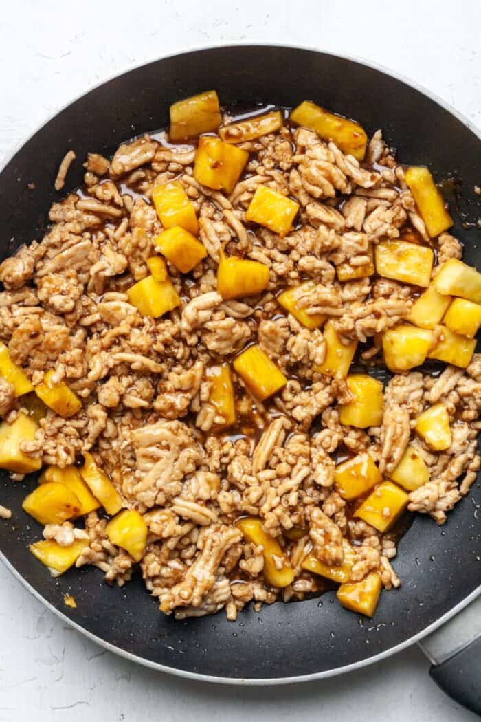 Ground chicken and pineapple in skillet