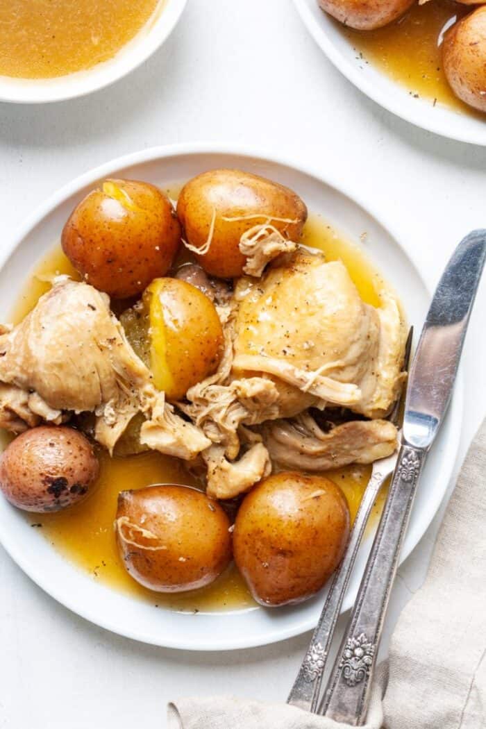 Instant Pot chicken thighs and potatoes on white plate