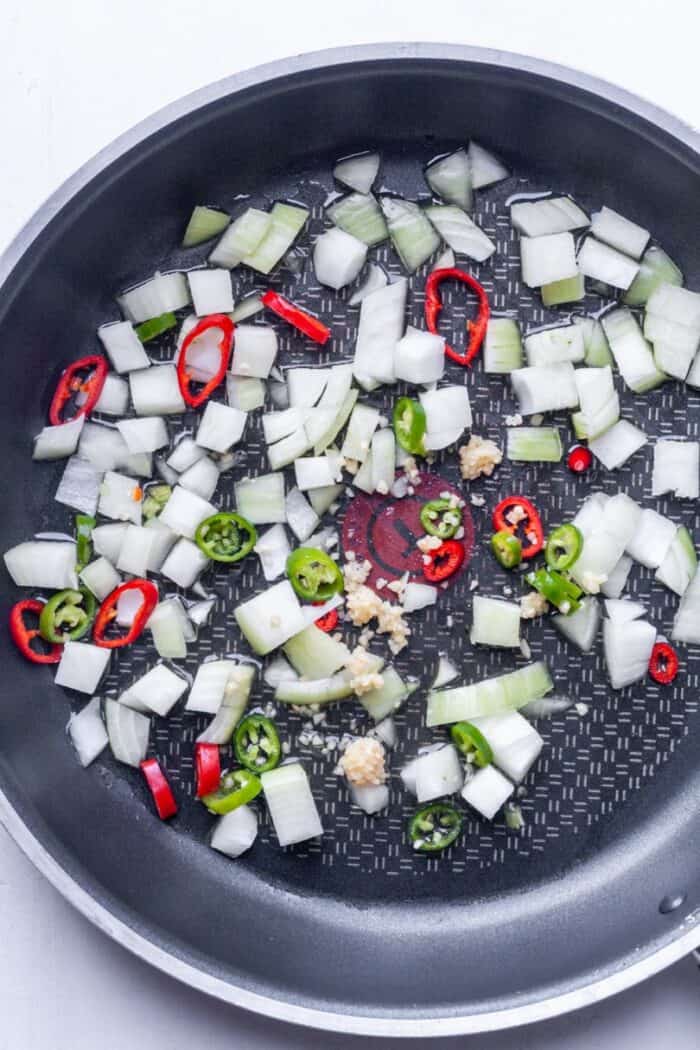 Diced onions and chili peppers in pan