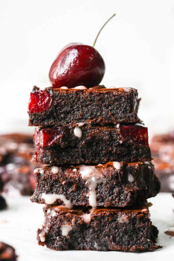 Stack of brownies with cherry on top