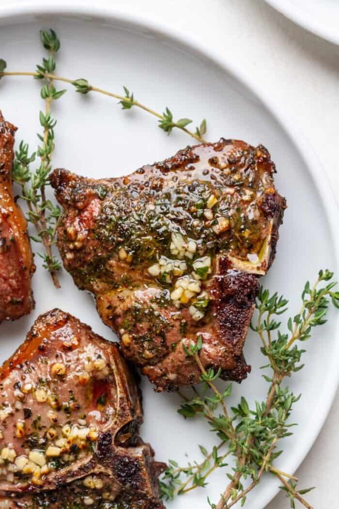 Lamb with thyme on white plate