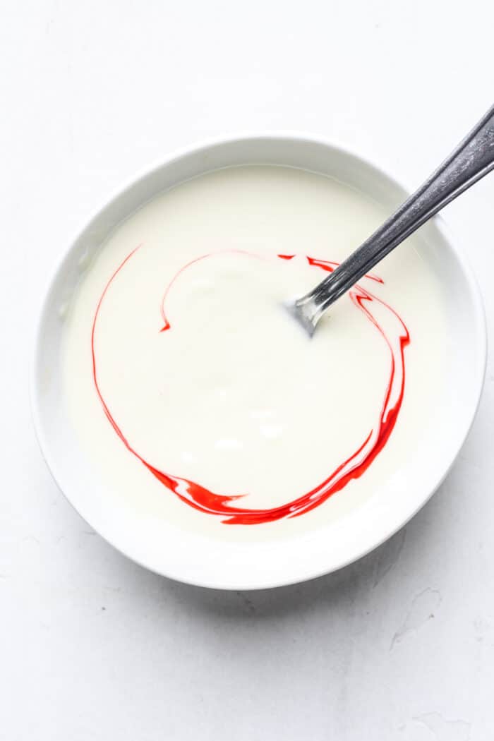 Bowl of white chocolate with red food coloring