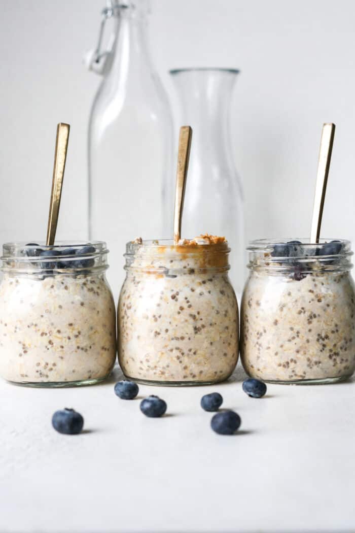 Protein overnight oats in jars with spoons