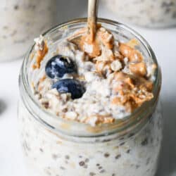 Jar of protein overnight oats with blueberries and peanut butter