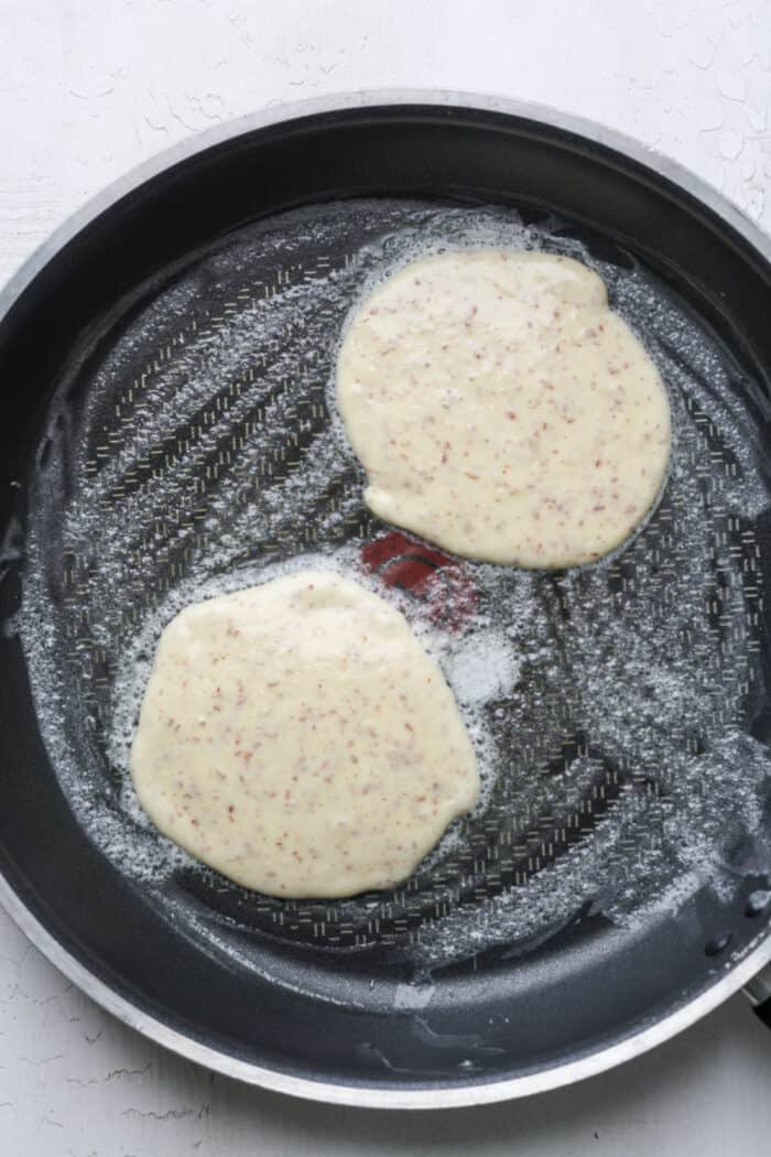 Raw pancakes in skillet