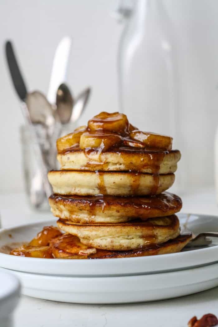 Stack of bananas foster pancakes with syrup