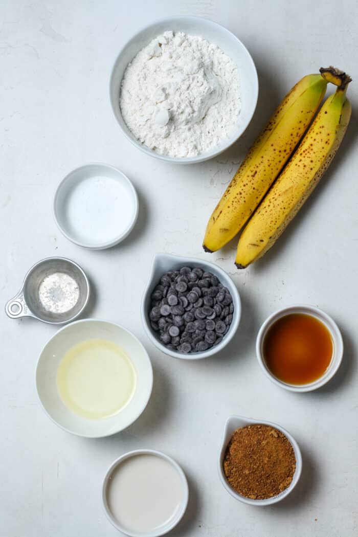 Bananas and ingredients in white bowls
