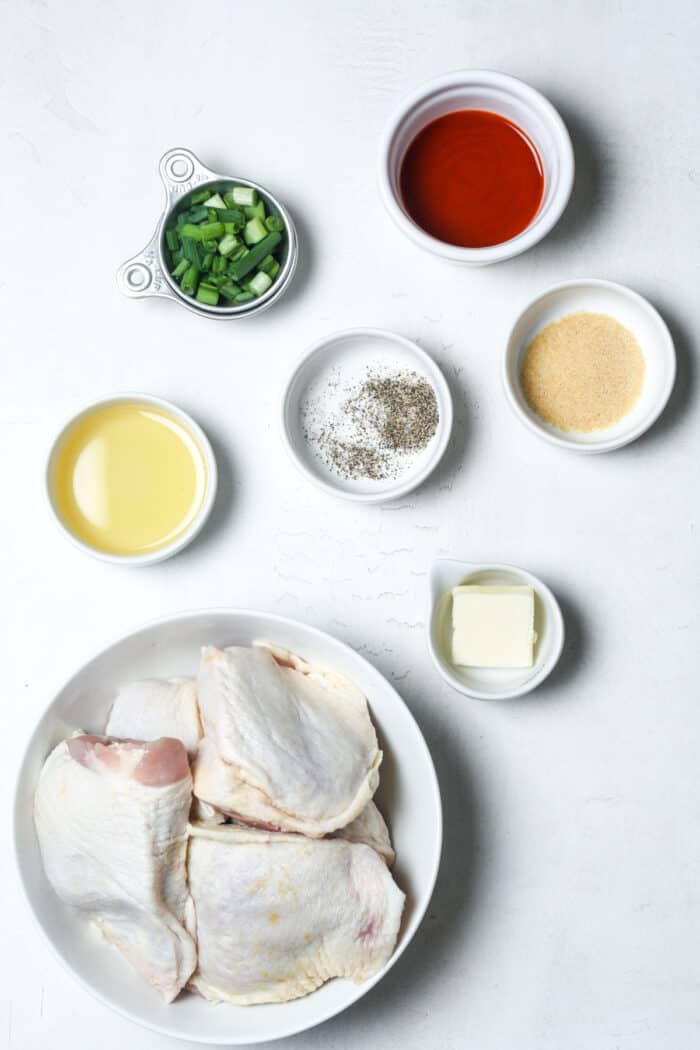 Chicken thighs and other ingredients in bowls