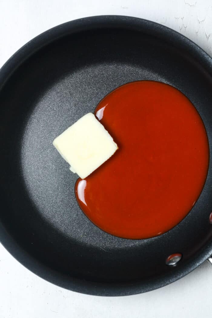 Hot sauce and butter in pan