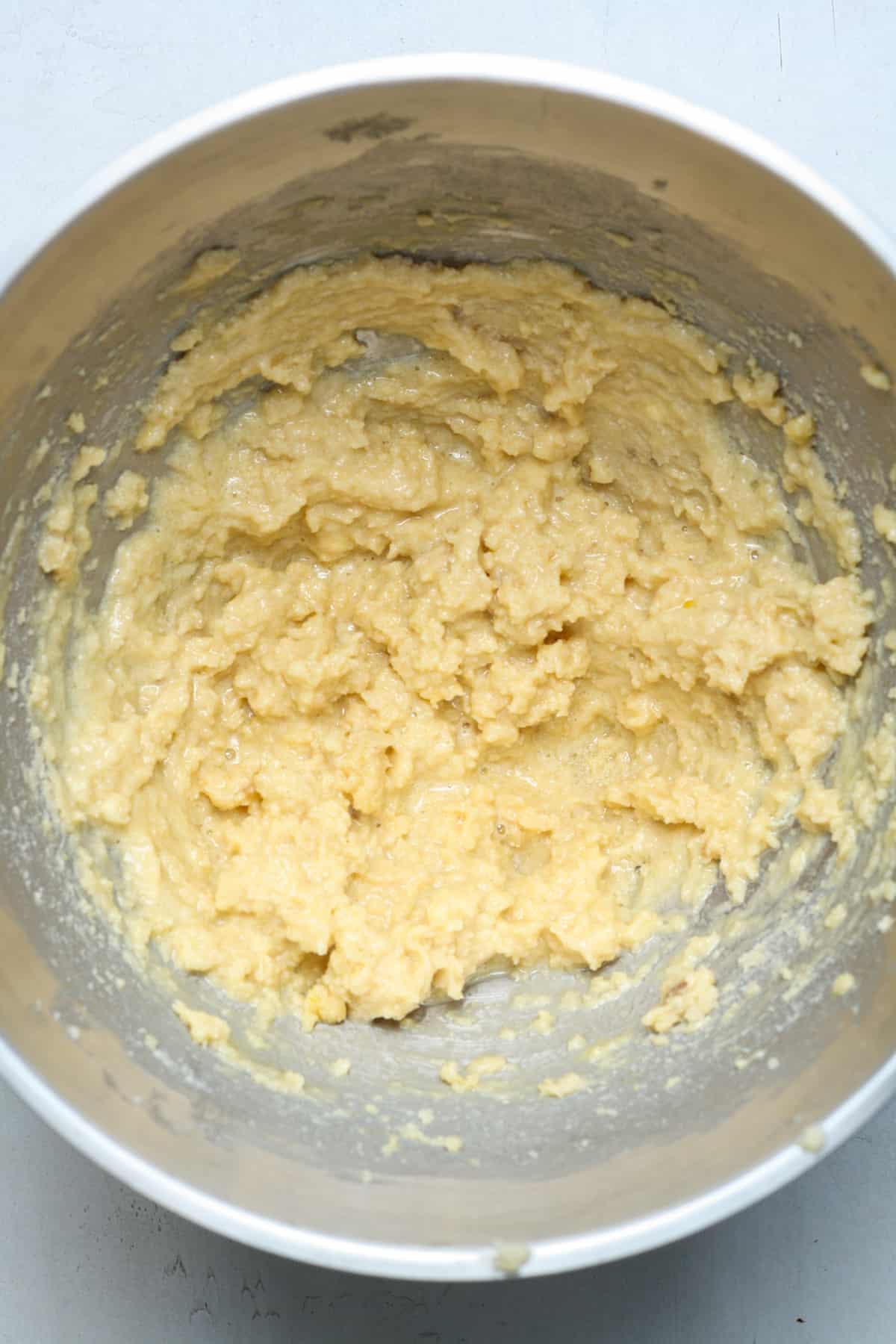 Creamy dough in mixing bowl