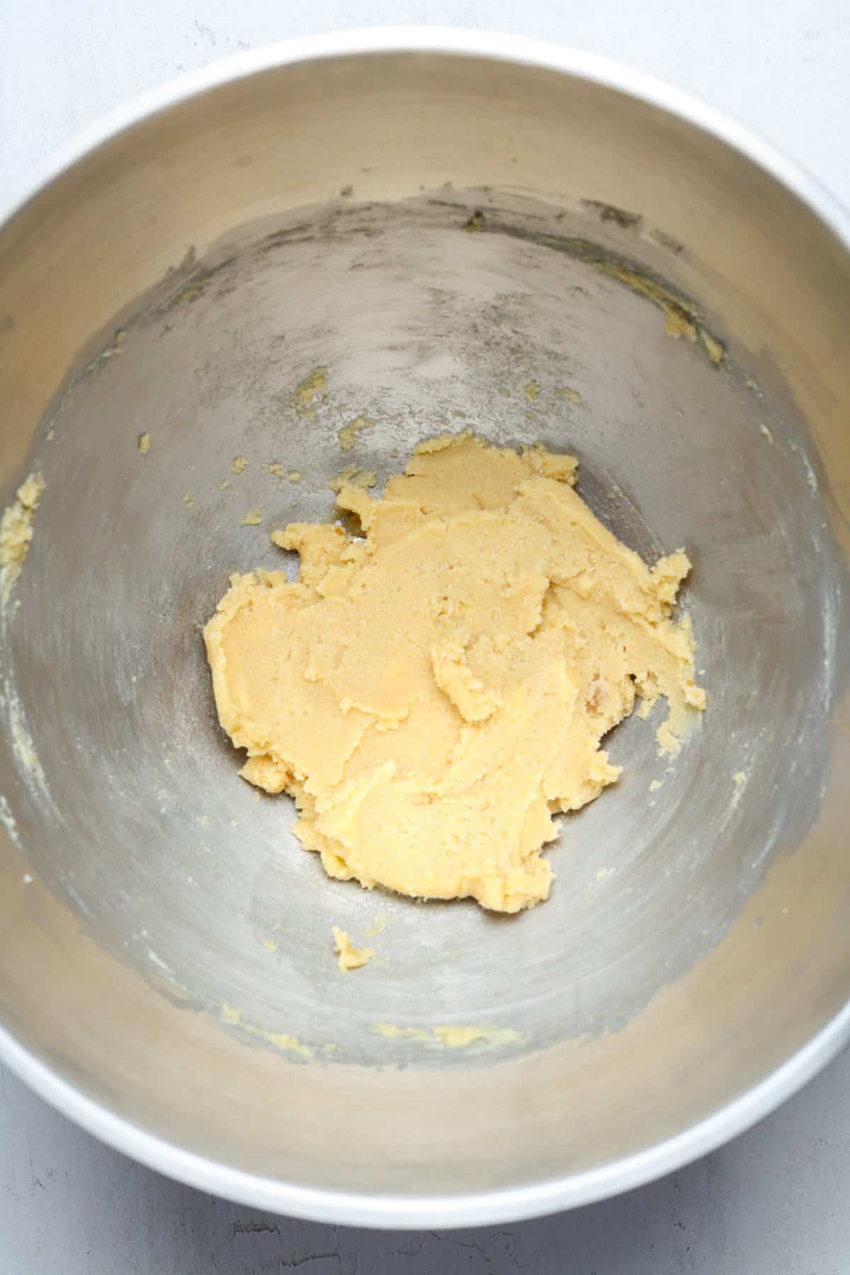 Creamy butter and sugars in bowl