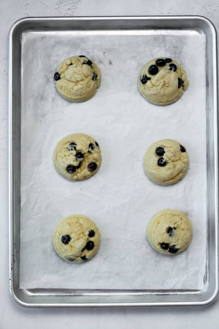 Soft baked blueberry lemon cookies on pan