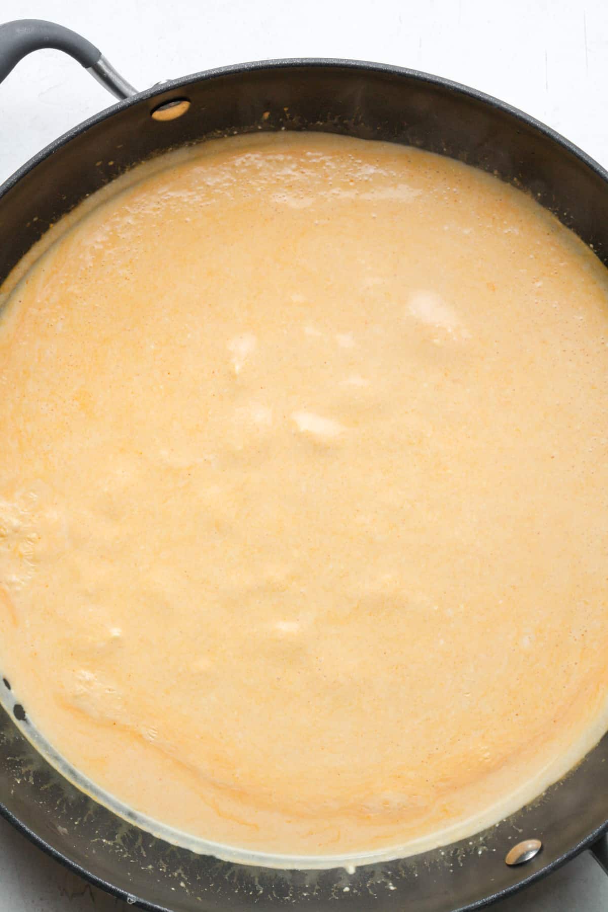 Creamy orange sauce in skillet