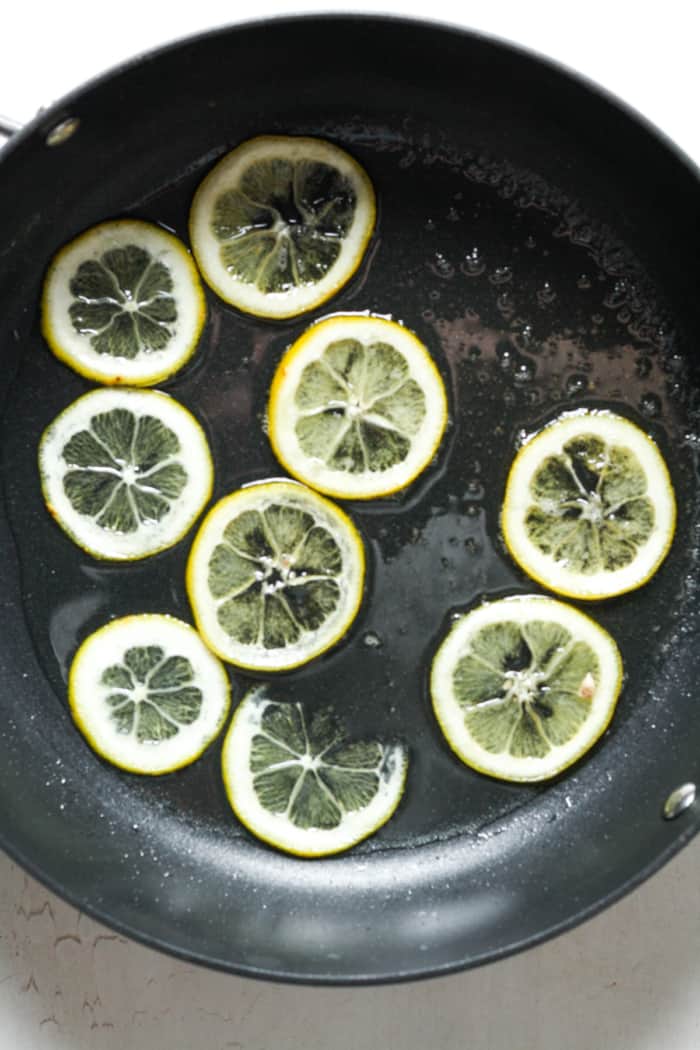 Candied lemons in pan.