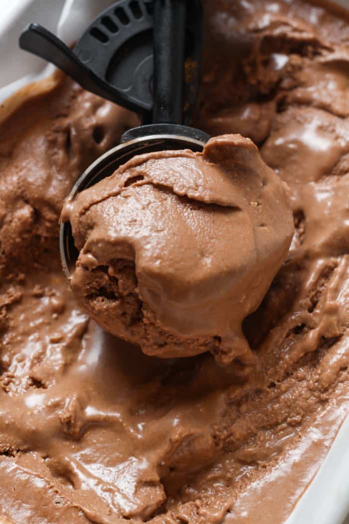 Chocolate ice cream with scooper.
