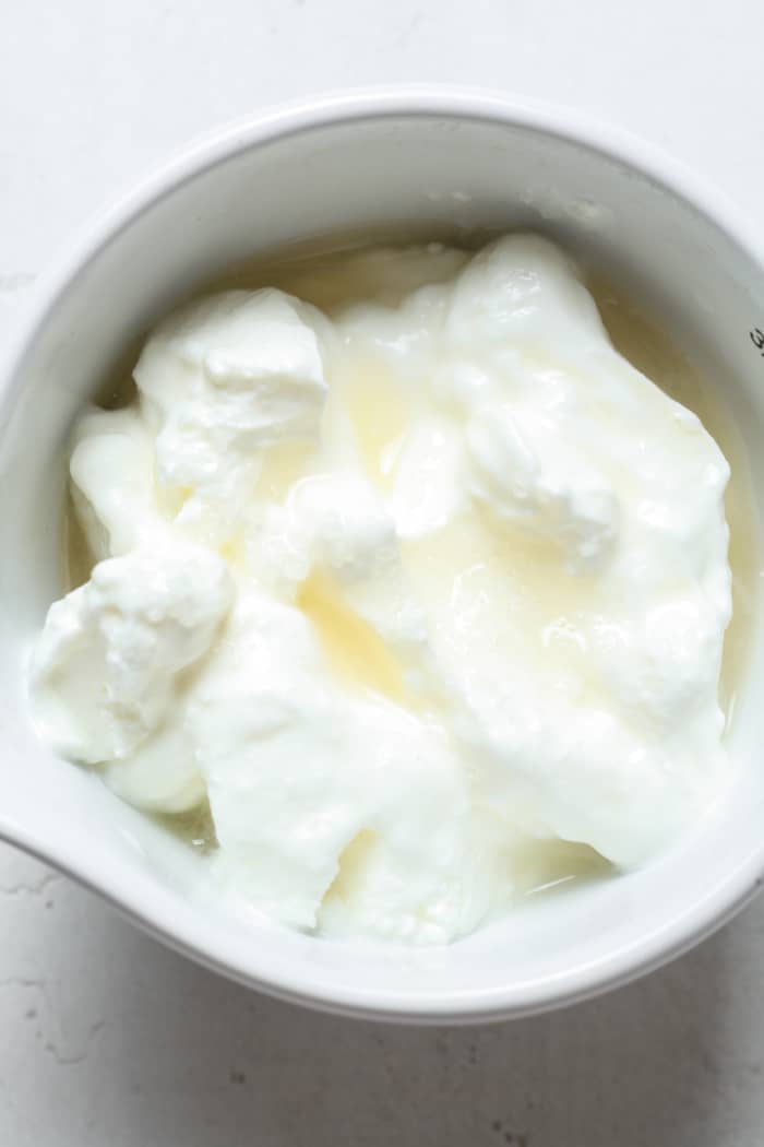 Watery sour cream in bowl.