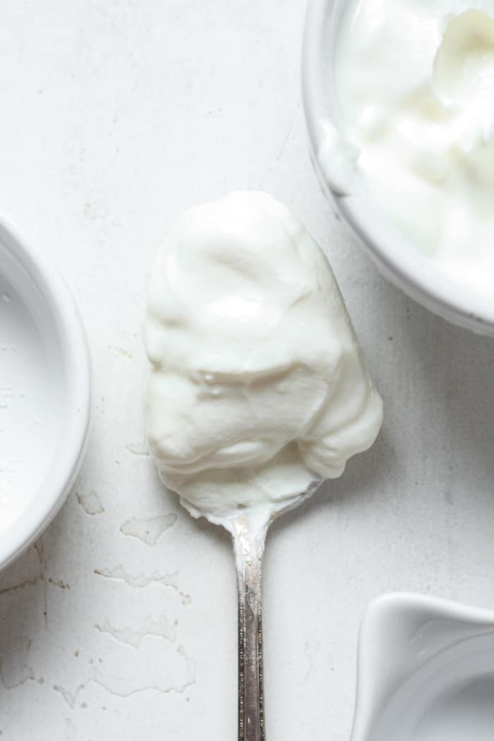Spoon of dairy free sour cream.