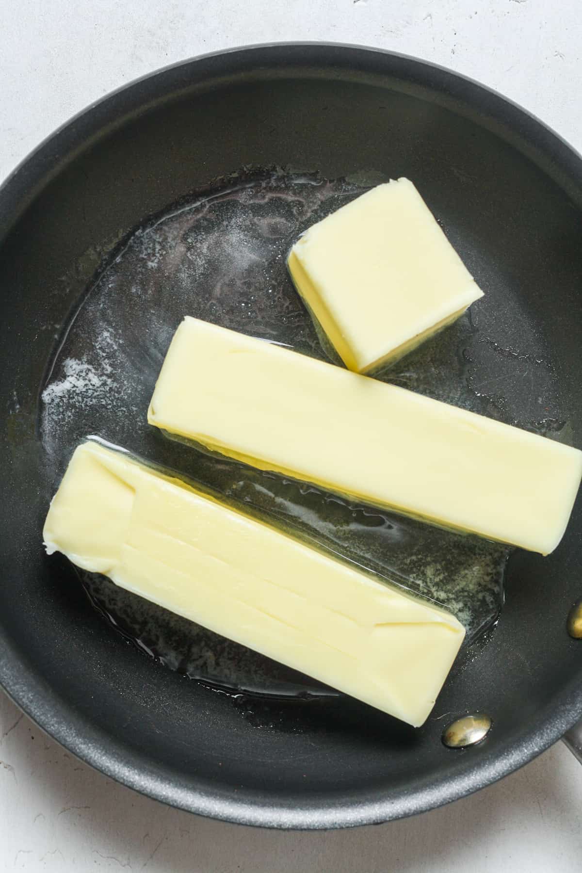 Sticks of butter in skillet.