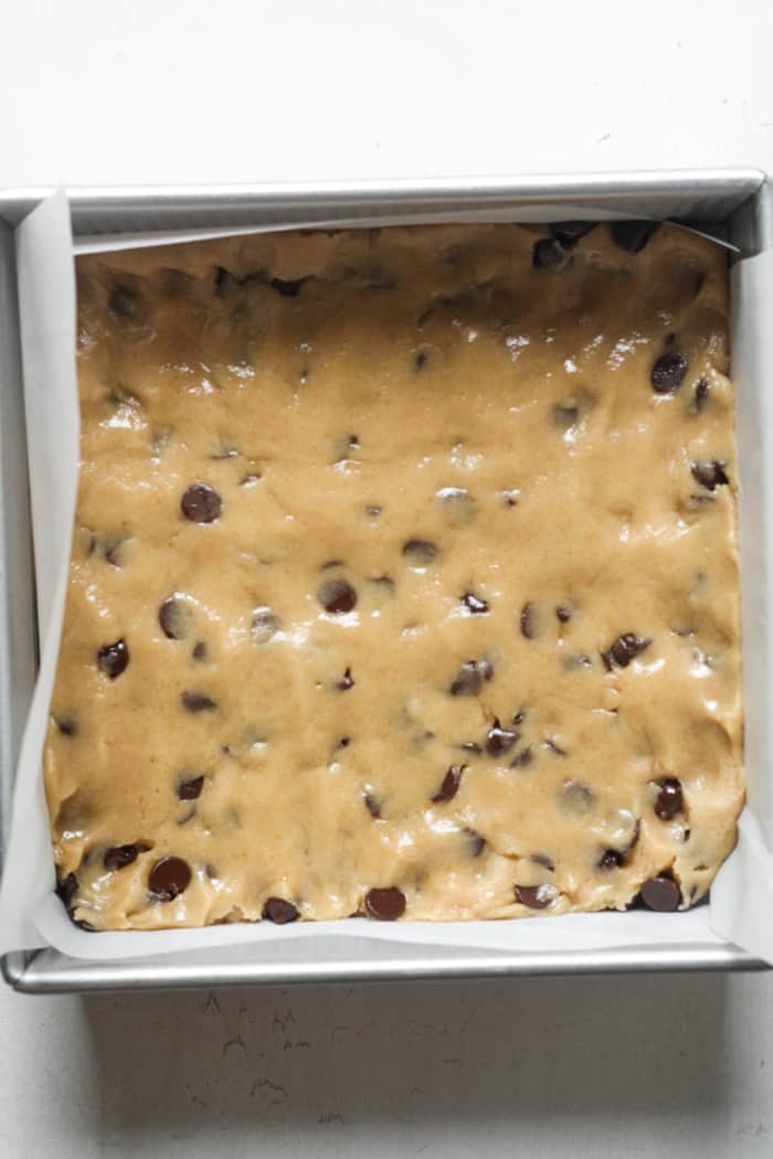 Raw cookie bars in pan.