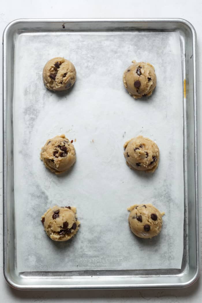 Cookie dough balls on pan.