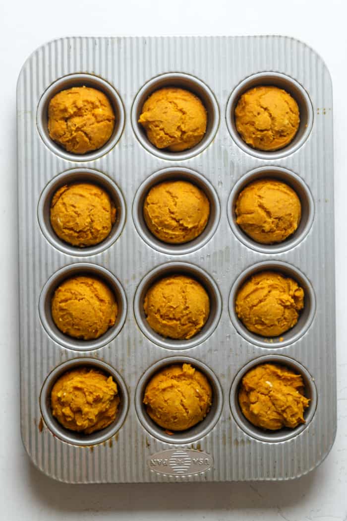 Baked pumpkin muffins in pan.