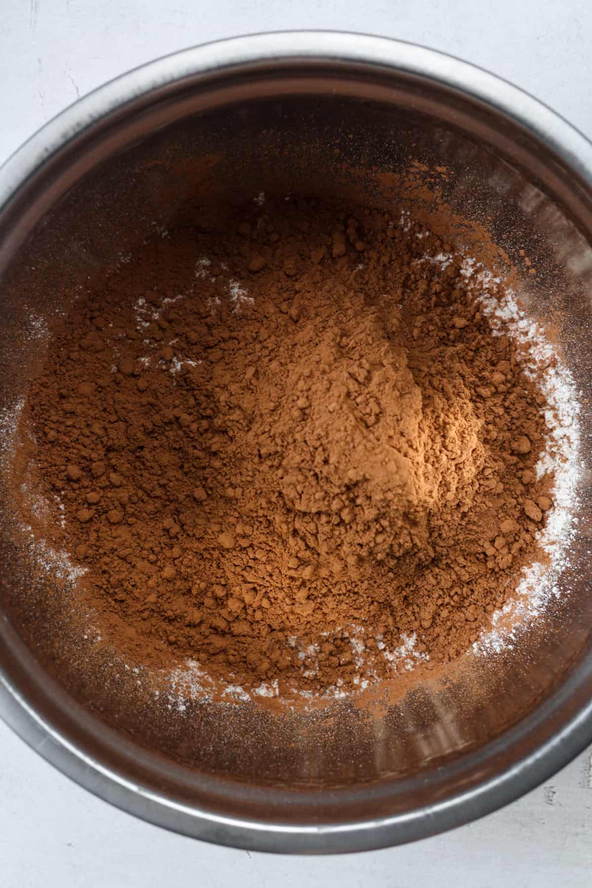 Dark cocoa powder in bowl.