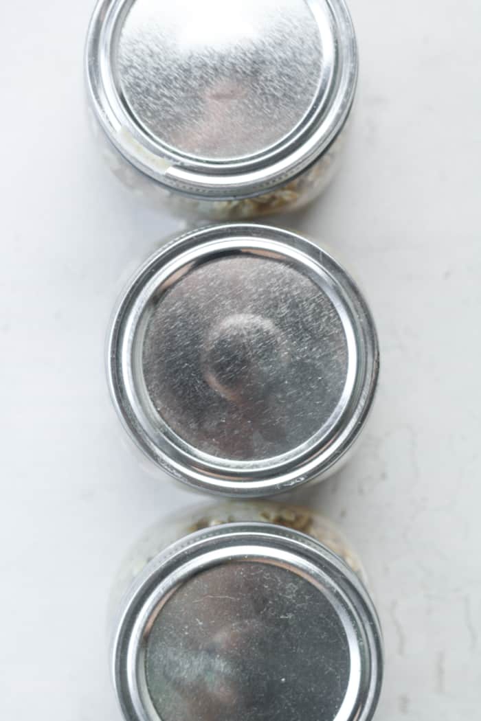 Three glass jars with lids.