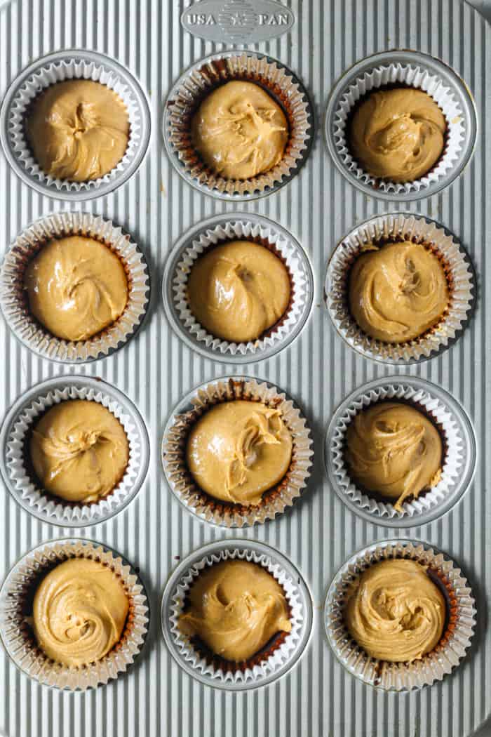 Peanut butter and chocolate in muffin pans.