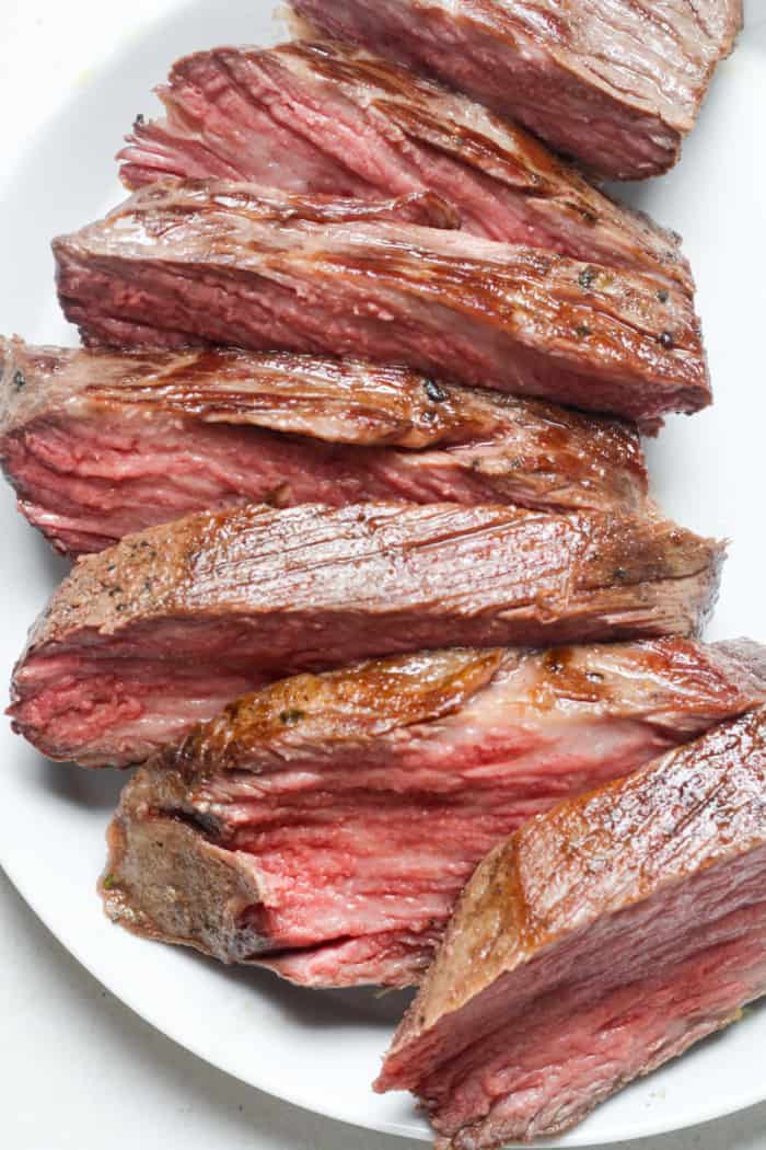 Sliced steak on plate.