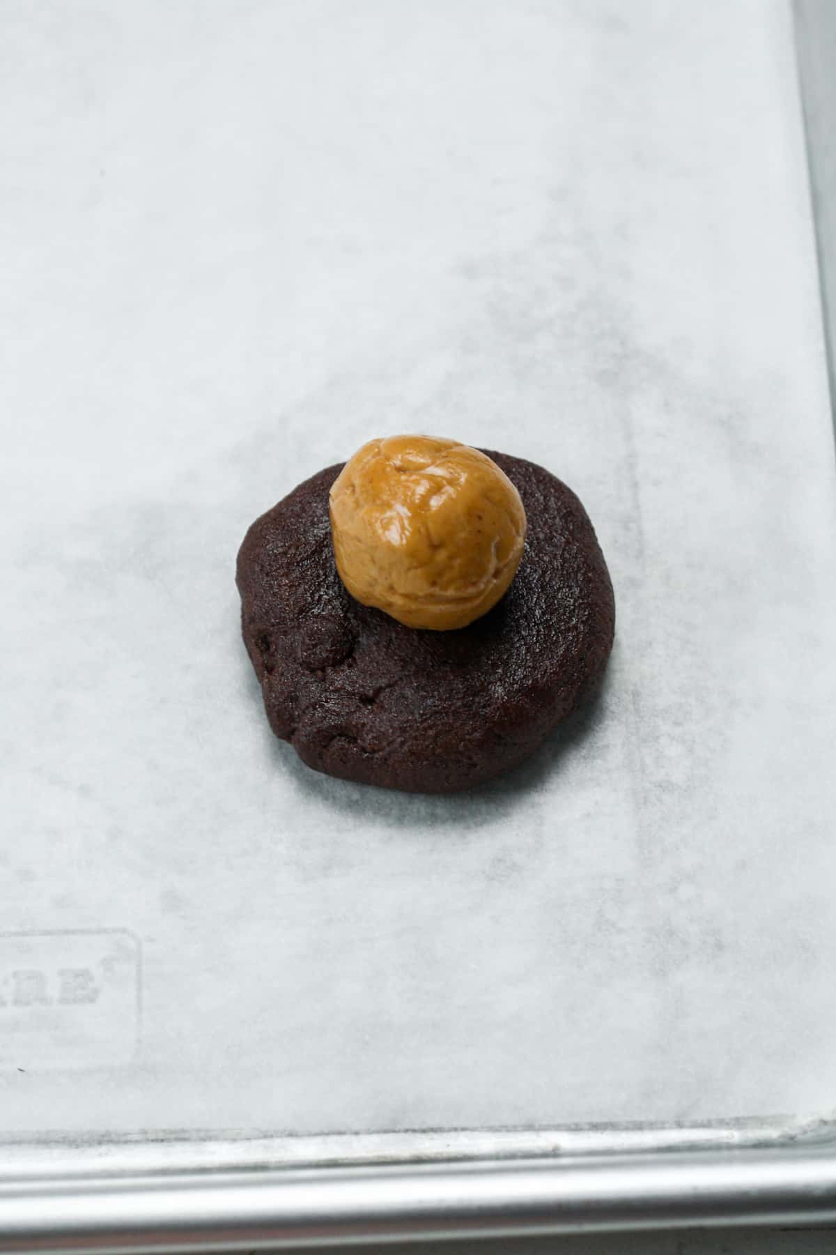 Peanut butter ball on chocolate cookie.