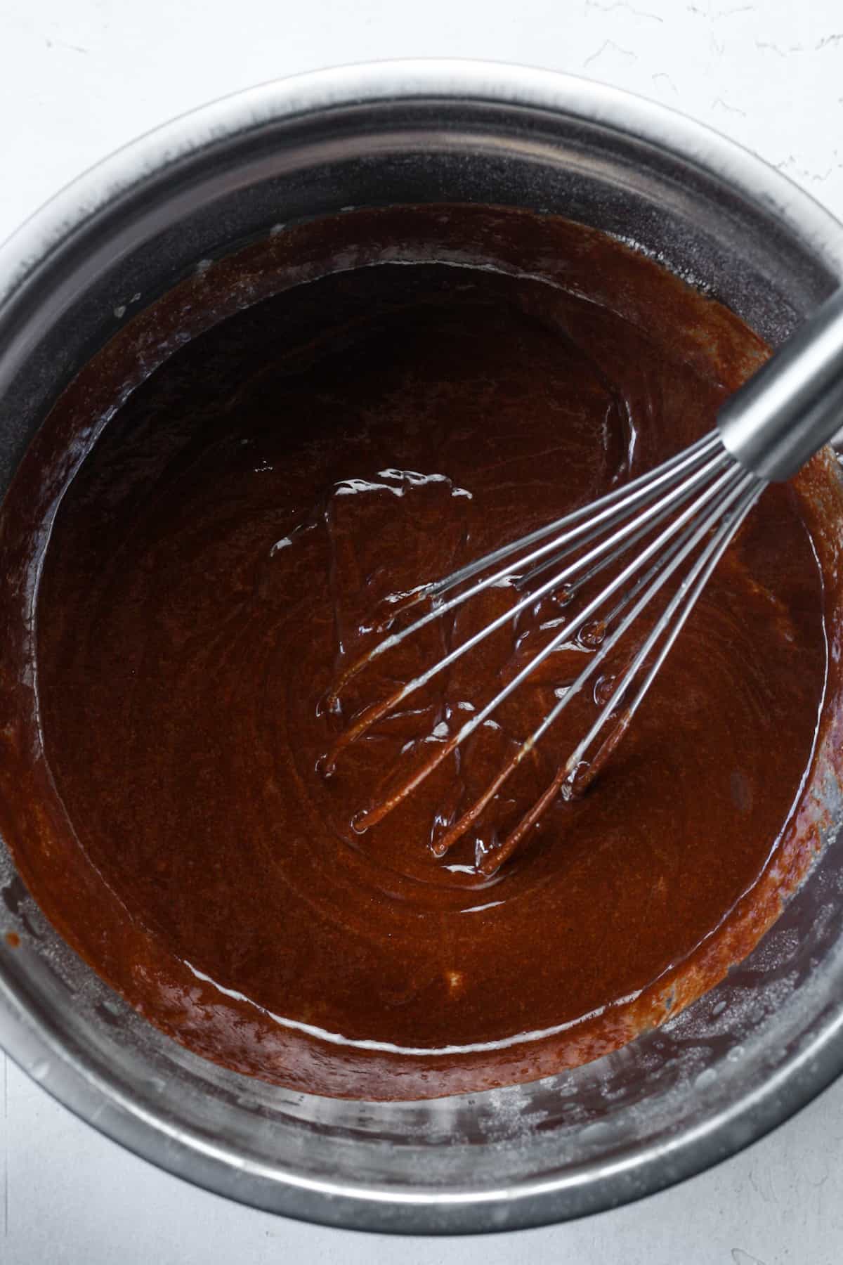Thick brownie batter in bowl.