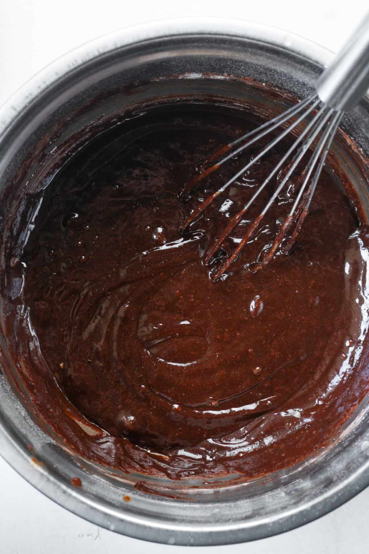 Whisked brownie batter in bowl.