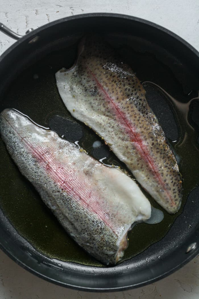 Rainbow trout in skillet.