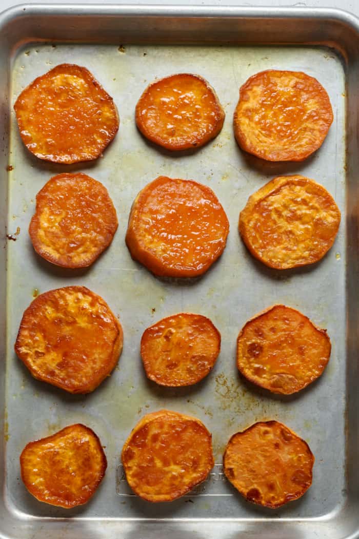 Baked sweet potatoes on pan.