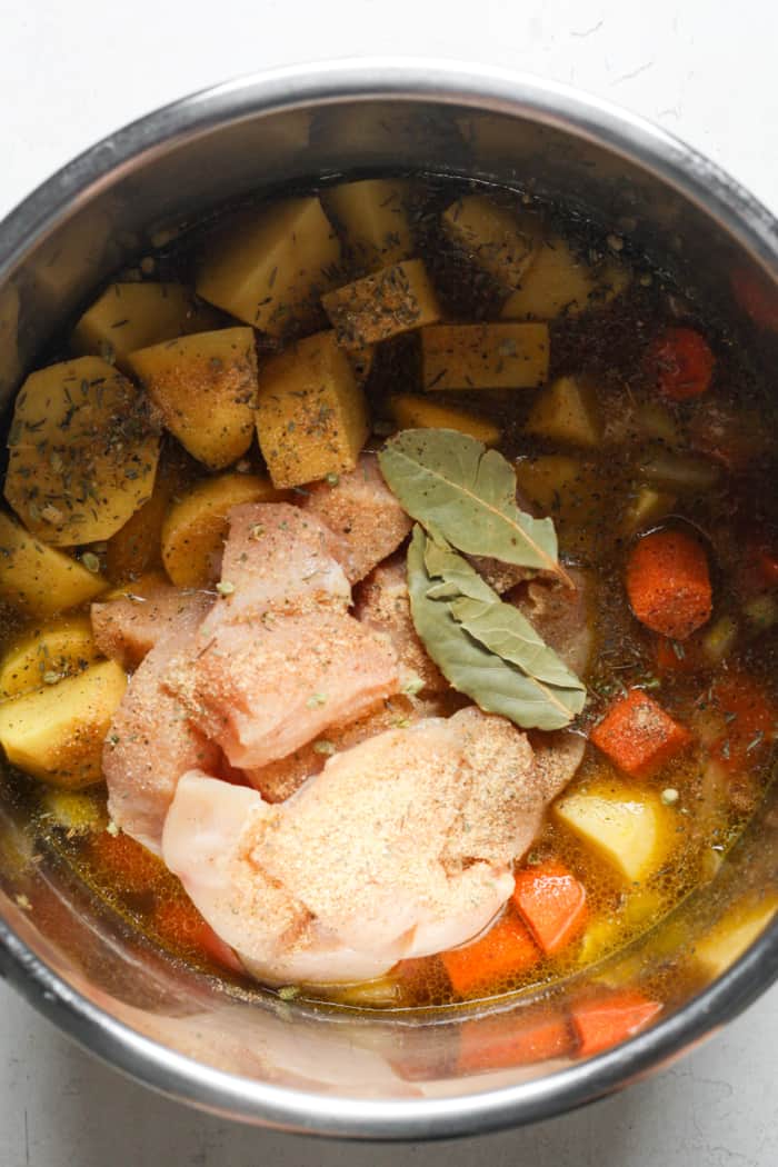 Chicken and potatoes in pot.