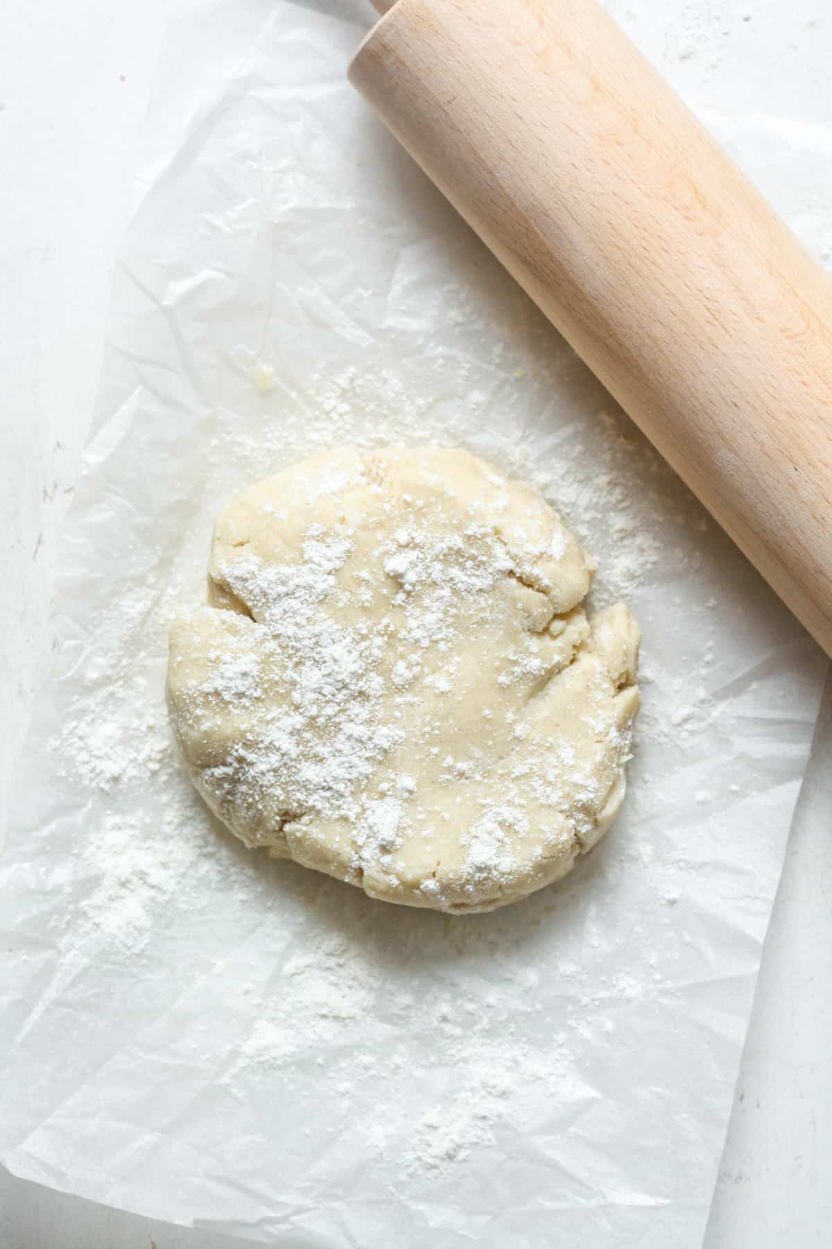 Disc of dough with rolling pin.