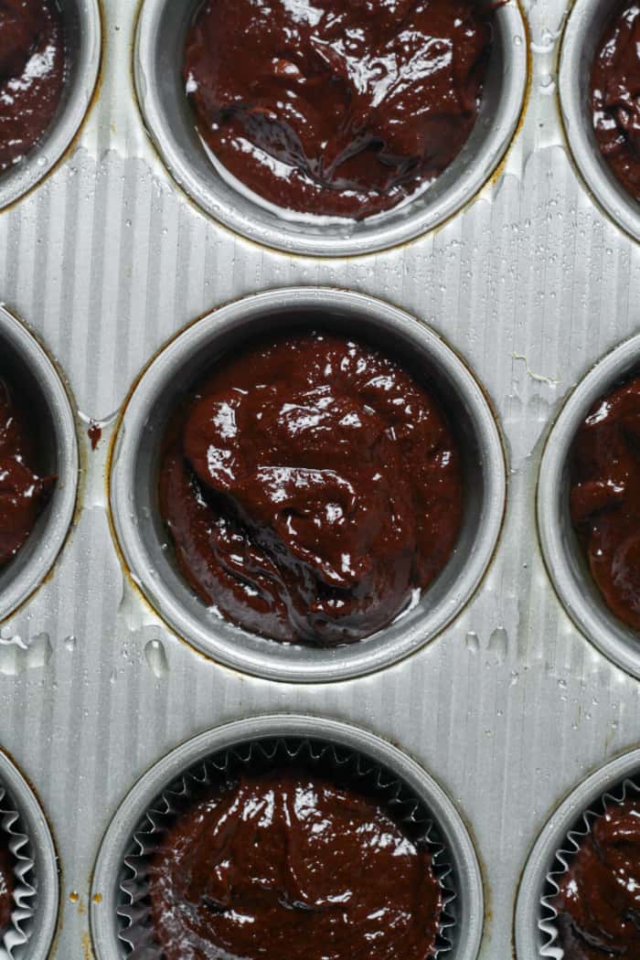 Muffin pan with brownie batter.