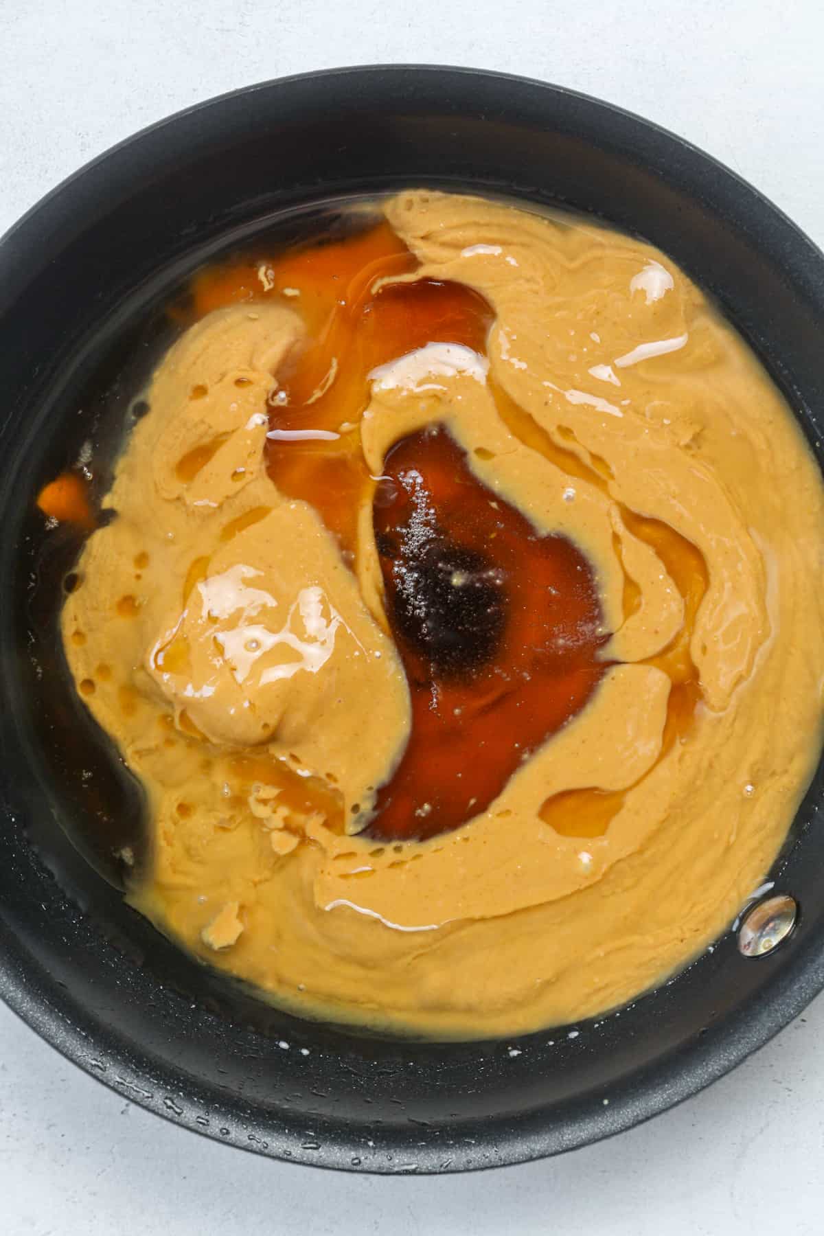 Peanut butter and syrup in skillet.