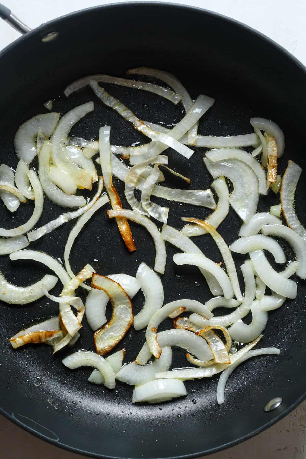 Tender onions in skillet.