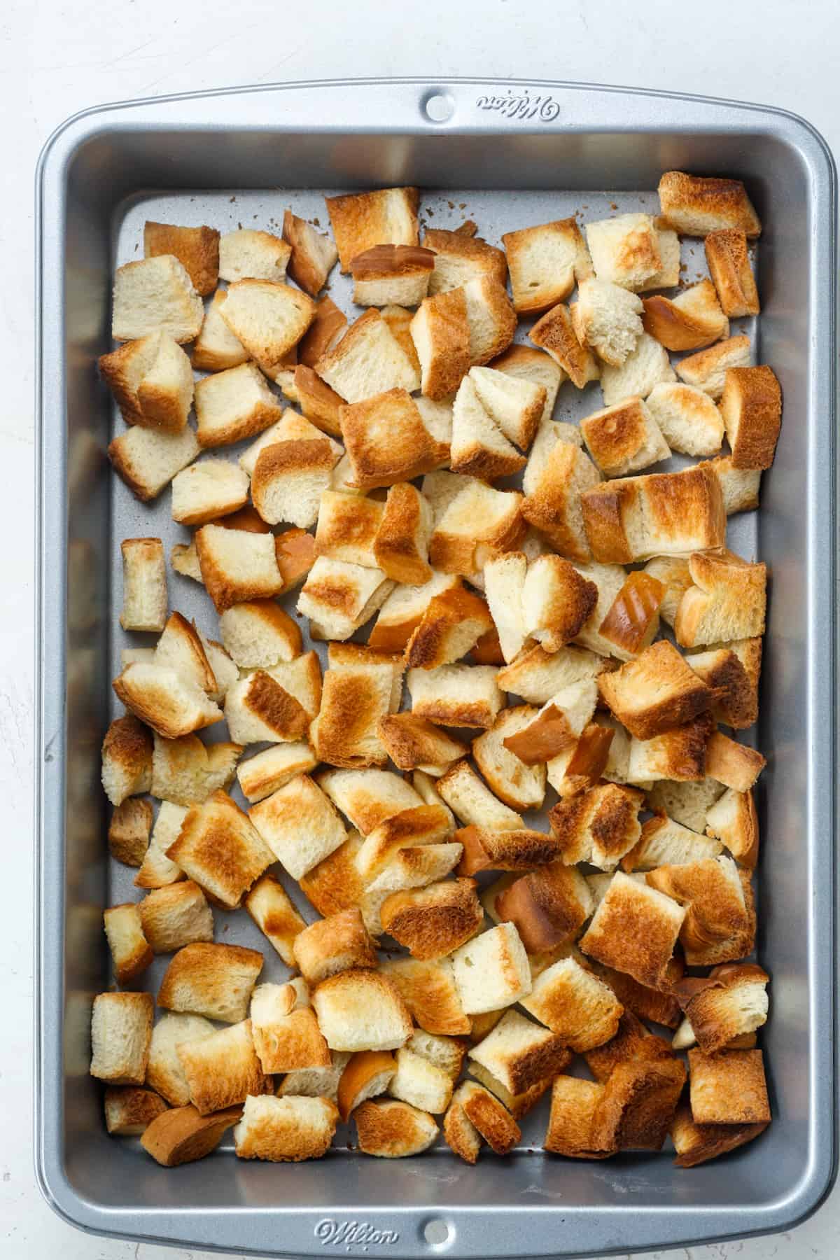 Homemade croutons in pan.