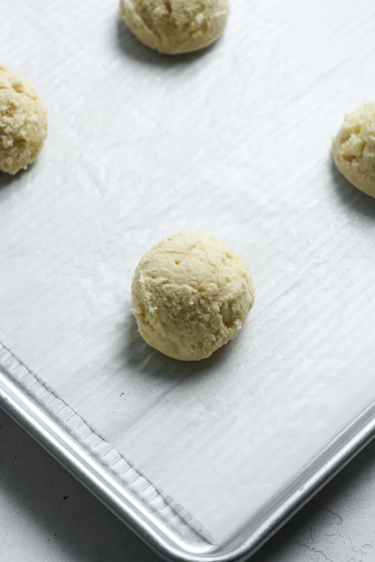 Dough balls on lined pan.