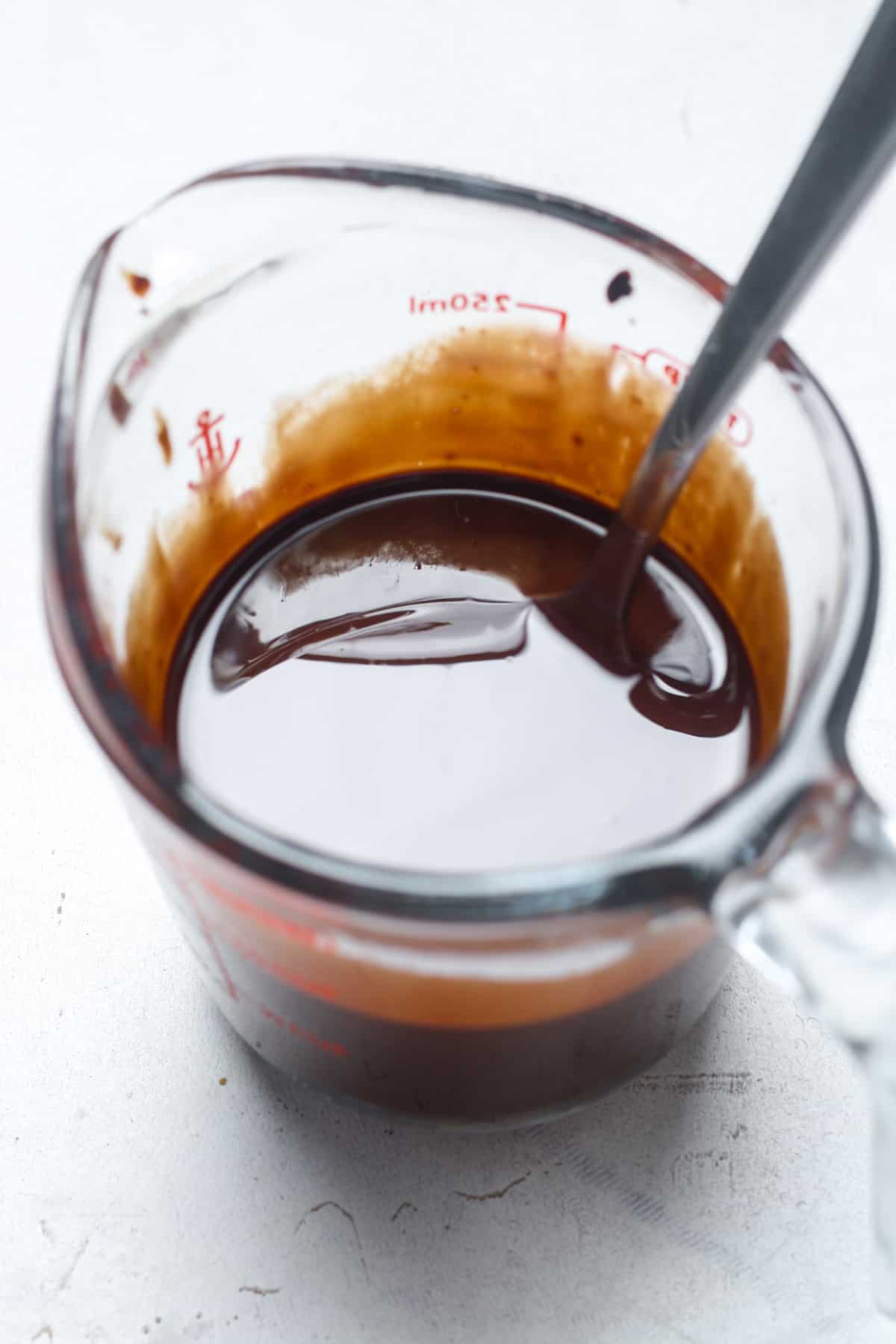 Melted chocolate in glass cup.