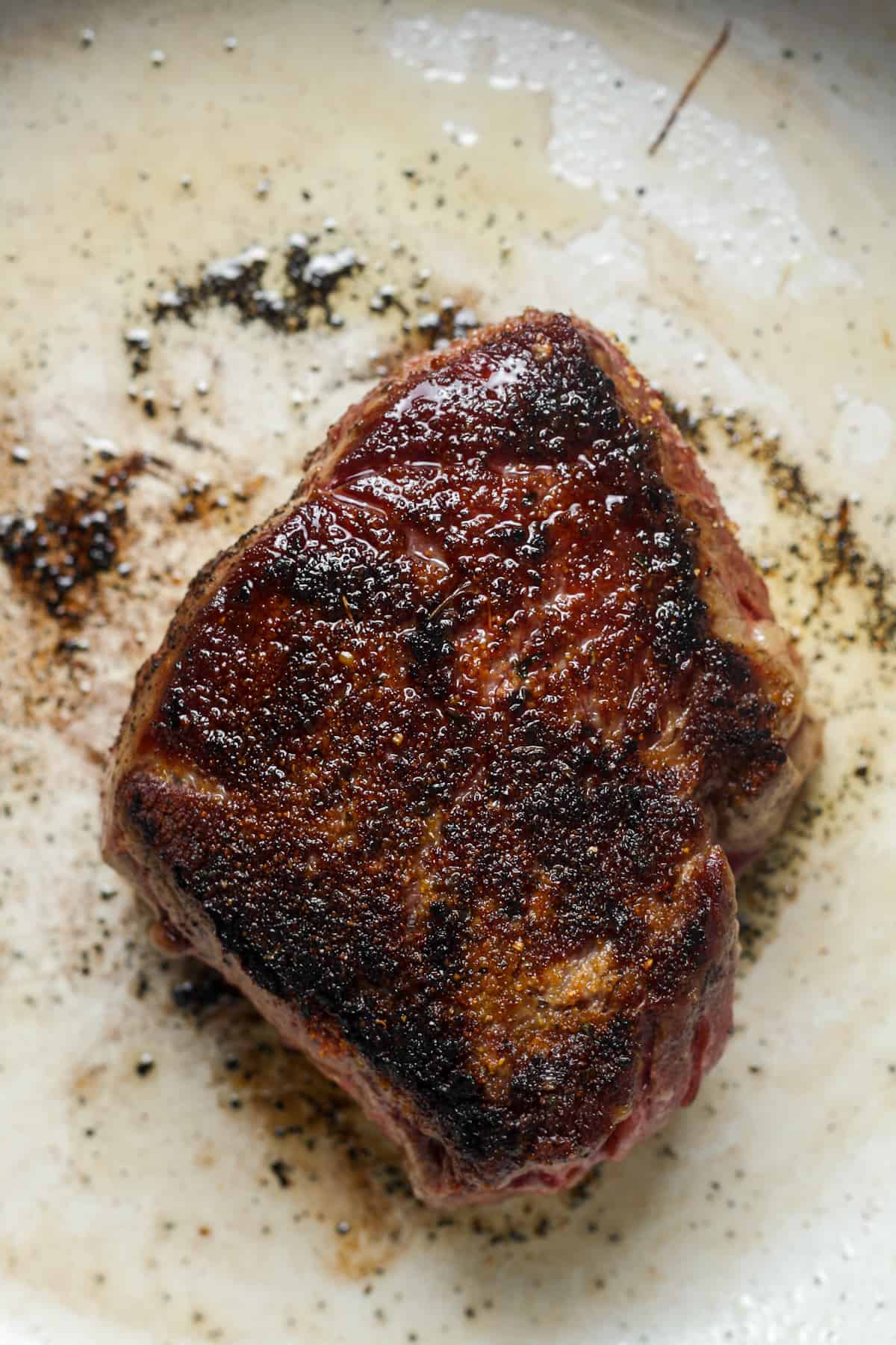 Thick steak with seasoning.
