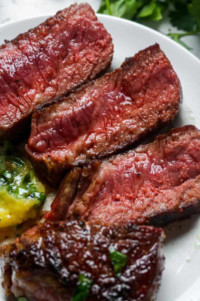 Medium rare steak on plate.
