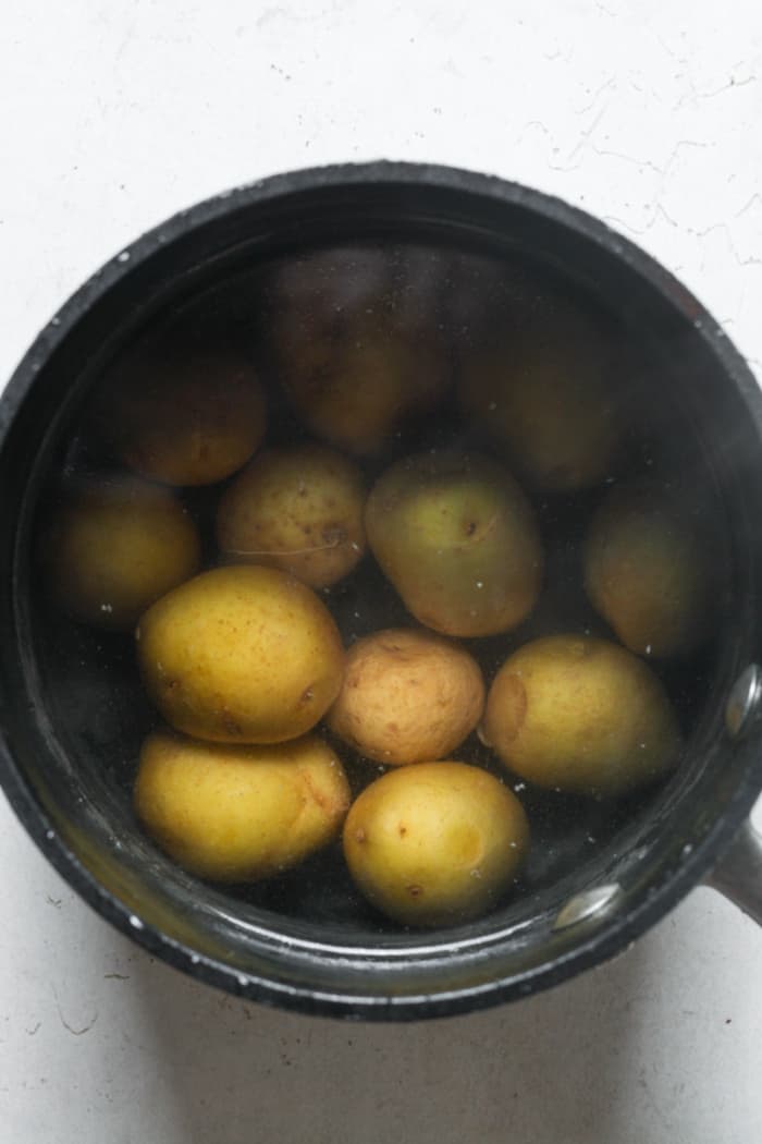 Golden potatoes in pan.